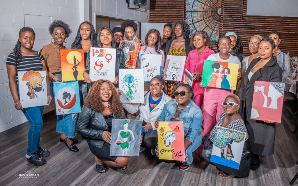 Women of CYAC with their paintings at the Women’s Day Paint and Sip, March 2025